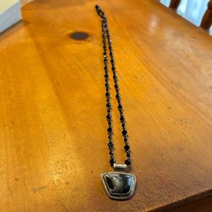 Beautiful black beaded necklace with a white and black stone